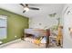 bedroom with bunk beds and dinosaur-themed decor, with neutral and olive walls at 1274 Pintail Pl, Lakeland, FL 33813