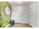 Stylish entryway with a round mirror, storage ottoman and wood-look flooring at 1274 Pintail Pl, Lakeland, FL 33813