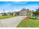 Attractive home with a verdant lawn, tidy landscaping, and a concrete driveway at 1274 Pintail Pl, Lakeland, FL 33813