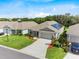 Well-maintained home exterior featuring lush landscaping, an attached two-car garage, and a solar panel array at 1274 Pintail Pl, Lakeland, FL 33813