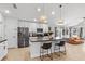 Modern kitchen with island seating and stainless steel appliances, open to living area at 1274 Pintail Pl, Lakeland, FL 33813