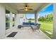 Covered patio featuring comfortable seating, ceiling fan, and backyard view at 1274 Pintail Pl, Lakeland, FL 33813