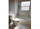 Updated bathroom with shower over bath featuring decorative marble wall and floor tiles at 130 Prima Dr, Kissimmee, FL 34759
