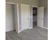 Neutral bedroom showcasing closet and views to the next room with modern gray walls and wood flooring at 130 Prima Dr, Kissimmee, FL 34759