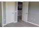 Neutral bedroom showcasing closet and views to the next room with modern gray walls and wood flooring at 130 Prima Dr, Kissimmee, FL 34759