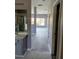Hallway view into living space and bathroom with gray walls and grey cabinets at 130 Prima Dr, Kissimmee, FL 34759