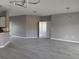 Open-concept living room with modern lighting, smooth walls and gray flooring at 130 Prima Dr, Kissimmee, FL 34759