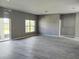 Expansive living room featuring modern lighting, a large window, and neutral color palette at 130 Prima Dr, Kissimmee, FL 34759