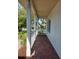 View from a cozy front porch with brick flooring and white columns at 130 Prima Dr, Kissimmee, FL 34759