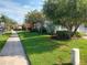 Neighborhood street view with well-manicured lawns and mature trees at 130 Prima Dr, Kissimmee, FL 34759