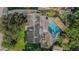 Aerial view of home featuring a pool, lush landscaping, and an outdoor deck at 1317 Avenue A Se, Winter Haven, FL 33880