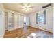 The bright bedroom features wood-look floors, a built in wardrobe, and a window for natural light at 1317 Avenue A Se, Winter Haven, FL 33880