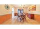 Formal dining room with seating for six and decorative sunset painting at 1317 Avenue A Se, Winter Haven, FL 33880