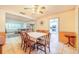 The dining room features a ceiling fan, orange walls and a wooden dining table set for six at 1317 Avenue A Se, Winter Haven, FL 33880
