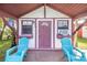 Charming outbuilding featuring a porch, two chairs, and a convenient air conditioning unit at 1317 Avenue A Se, Winter Haven, FL 33880