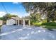 View of home with a white-columned carport and a shed-style structure in the backyard at 1317 Avenue A Se, Winter Haven, FL 33880