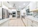Bright kitchen features stainless steel appliances, white cabinetry, tile backsplash, and tile flooring at 1317 Avenue A Se, Winter Haven, FL 33880