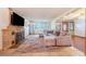 Cozy living room with a fireplace, large sofa, and stone flooring at 1317 Avenue A Se, Winter Haven, FL 33880