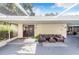 An outdoor covered patio with wicker furniture set and tile flooring at 1317 Avenue A Se, Winter Haven, FL 33880