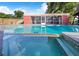 In-ground pool featuring clear blue water, surrounding patio, and screened-in porch at 1317 Avenue A Se, Winter Haven, FL 33880