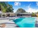 Large in-ground pool and surrounding patio, perfect for entertaining and relaxation at 1317 Avenue A Se, Winter Haven, FL 33880