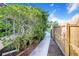 A side yard is seen with a wooden fence and shrubbery at 1317 Avenue A Se, Winter Haven, FL 33880