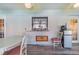 Bright sunroom features white brick walls, a dining area, a pass-through to the kitchen, and a mini-refrigerator at 1317 Avenue A Se, Winter Haven, FL 33880