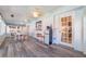 Inviting sunroom with many windows, a dining area, and a mini bar with a mini-refrigerator at 1317 Avenue A Se, Winter Haven, FL 33880