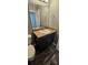 Bathroom featuring a vanity with granite counters and dark wood cabinets over dark wood laminate flooring at 1318 Herschell St, Lakeland, FL 33815