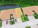 Overhead aerial view of a home showcasing its layout, landscaping, and proximity to a pond at 1349 Innsbruck Ct, Winter Haven, FL 33884
