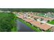 Stunning aerial view of a residential area highlighting the beautiful pond and surrounding natural landscape at 1349 Innsbruck Ct, Winter Haven, FL 33884