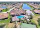 Community aerial view featuring a pool, lake, and tennis court at 1349 Innsbruck Ct, Winter Haven, FL 33884