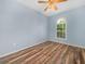 Bedroom with a ceiling fan, hardwood floors, and a window that lets in natural light at 1349 Innsbruck Ct, Winter Haven, FL 33884