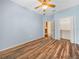 Bedroom with ceiling fan and access to both a walk-in closet and an en suite bathroom at 1349 Innsbruck Ct, Winter Haven, FL 33884