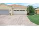 Well-maintained home with a brick paver driveway that leads to a two car garage with beautiful landscaping at 1349 Innsbruck Ct, Winter Haven, FL 33884