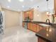 Bright kitchen features stainless steel appliances, tile floors, and natural wood cabinets at 1349 Innsbruck Ct, Winter Haven, FL 33884
