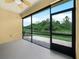 The screened lanai showcases serene water views, brick pavers, and a ceiling fan, perfect for relaxation and enjoying the outdoors at 1349 Innsbruck Ct, Winter Haven, FL 33884