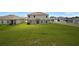 Spacious backyard featuring lush green grass and views of neighboring homes at 137 Piave St, Haines City, FL 33844