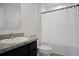 A bathroom featuring a dark vanity and shower with white curtain at 137 Piave St, Haines City, FL 33844