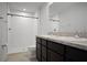Bright bathroom featuring a double sink vanity and a walk-in shower with tiled walls at 137 Piave St, Haines City, FL 33844
