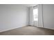Bedroom featuring neutral carpet, bright light from the window and white curtains at 137 Piave St, Haines City, FL 33844