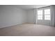 Bedroom featuring two windows with modern drapery, neutral paint, and carpet at 137 Piave St, Haines City, FL 33844