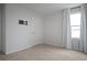 Neutral bedroom features a window providing natural light and a wall-mounted TV bracket at 137 Piave St, Haines City, FL 33844