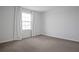 A bedroom with neutral carpet, bright light from the window and white curtains at 137 Piave St, Haines City, FL 33844