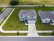 Aerial view of a two-story home featuring a well-manicured lawn and gray color scheme at 137 Piave St, Haines City, FL 33844