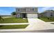 Well-maintained two-story home features a spacious driveway and manicured lawn with minimal landscaping at 137 Piave St, Haines City, FL 33844