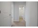 Neutral hallway showing multiple rooms, carpeted floors and white paint at 137 Piave St, Haines City, FL 33844