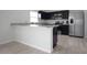 Modern kitchen boasts black cabinetry, stainless steel appliances, and elegant countertops at 137 Piave St, Haines City, FL 33844