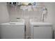 A laundry room with white appliances, shelving and neutral walls at 137 Piave St, Haines City, FL 33844