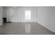 Bright living room with ample space, light gray flooring, and a door to the outside at 137 Piave St, Haines City, FL 33844
